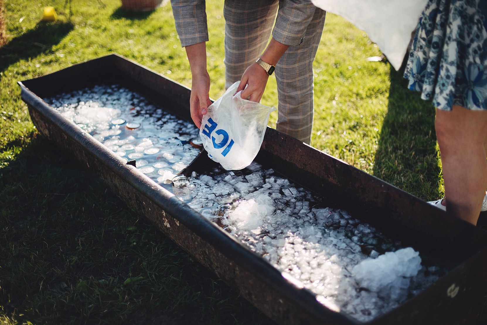 Filling a trough full of Ice for beers at a wedding