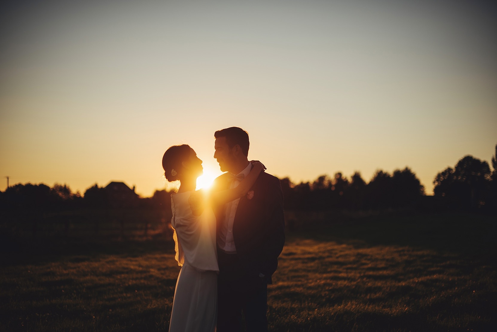 Bride and Groom at sunset in an open field