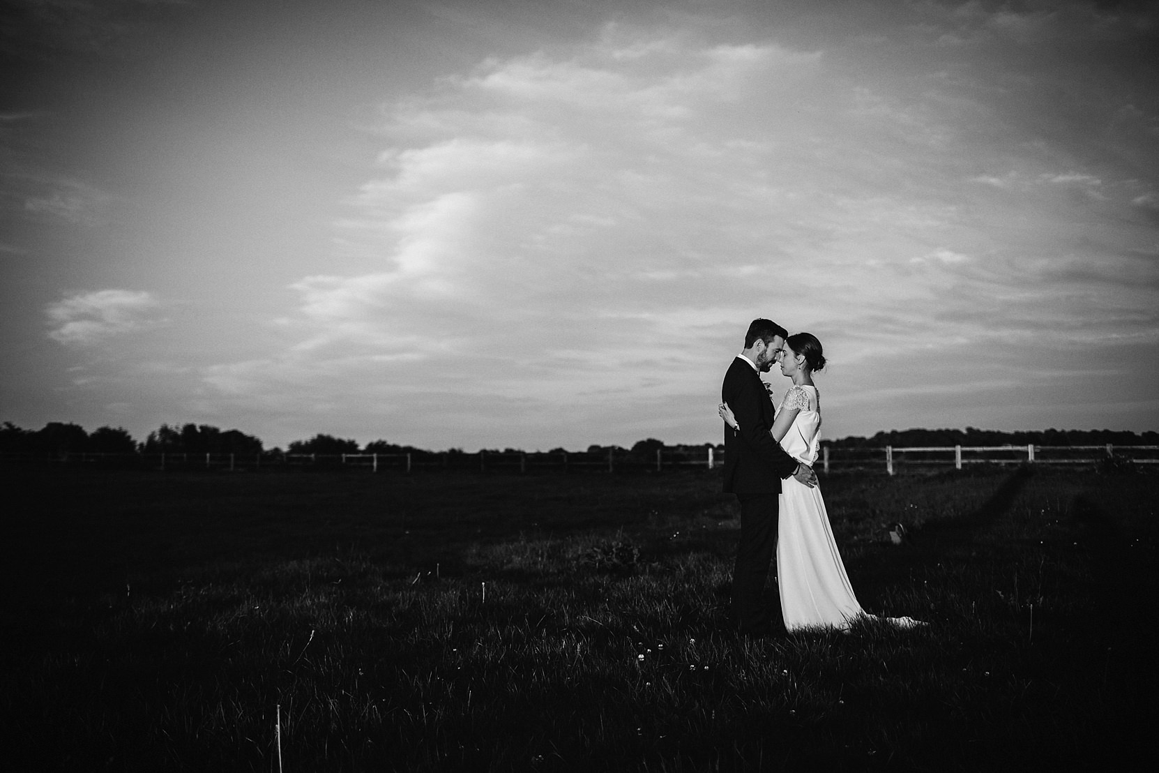 Romantic shot of a bride and groom in a beautiful setting at sunset