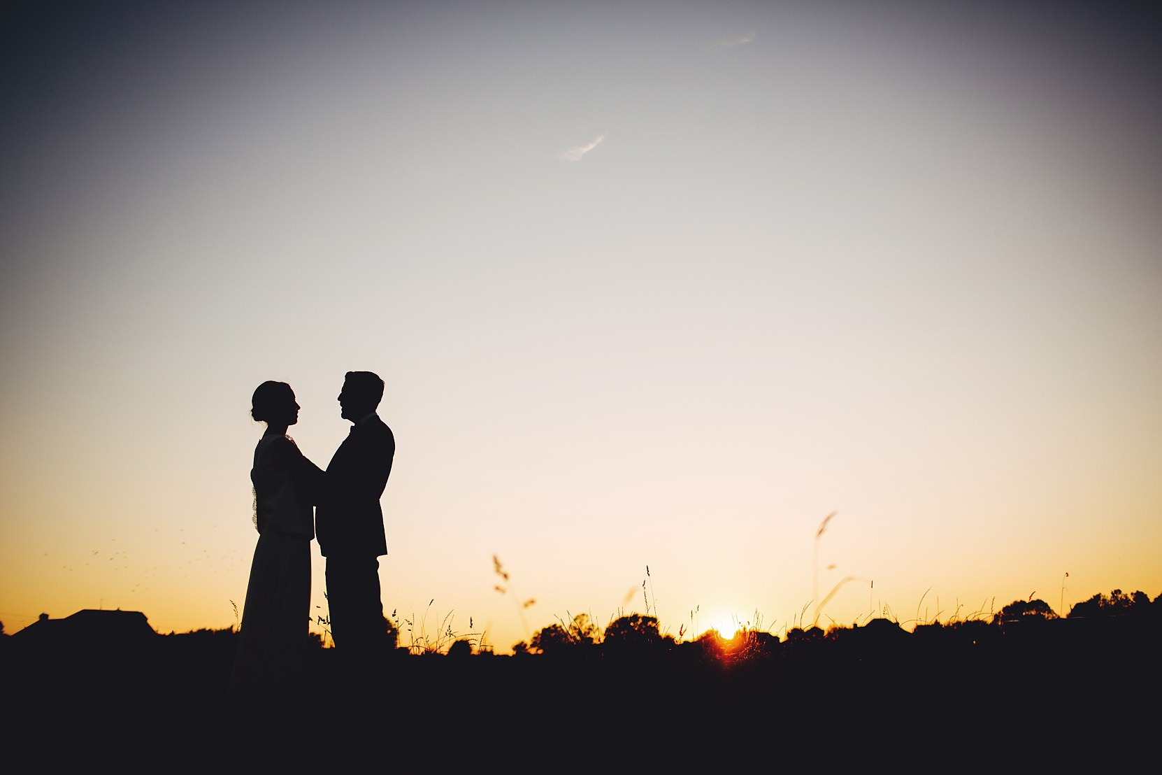 Romantic shot of a bride and groom in a beautiful setting at sunset